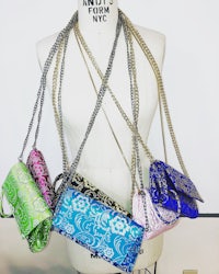 four colorful purses on a mannequin mannequin